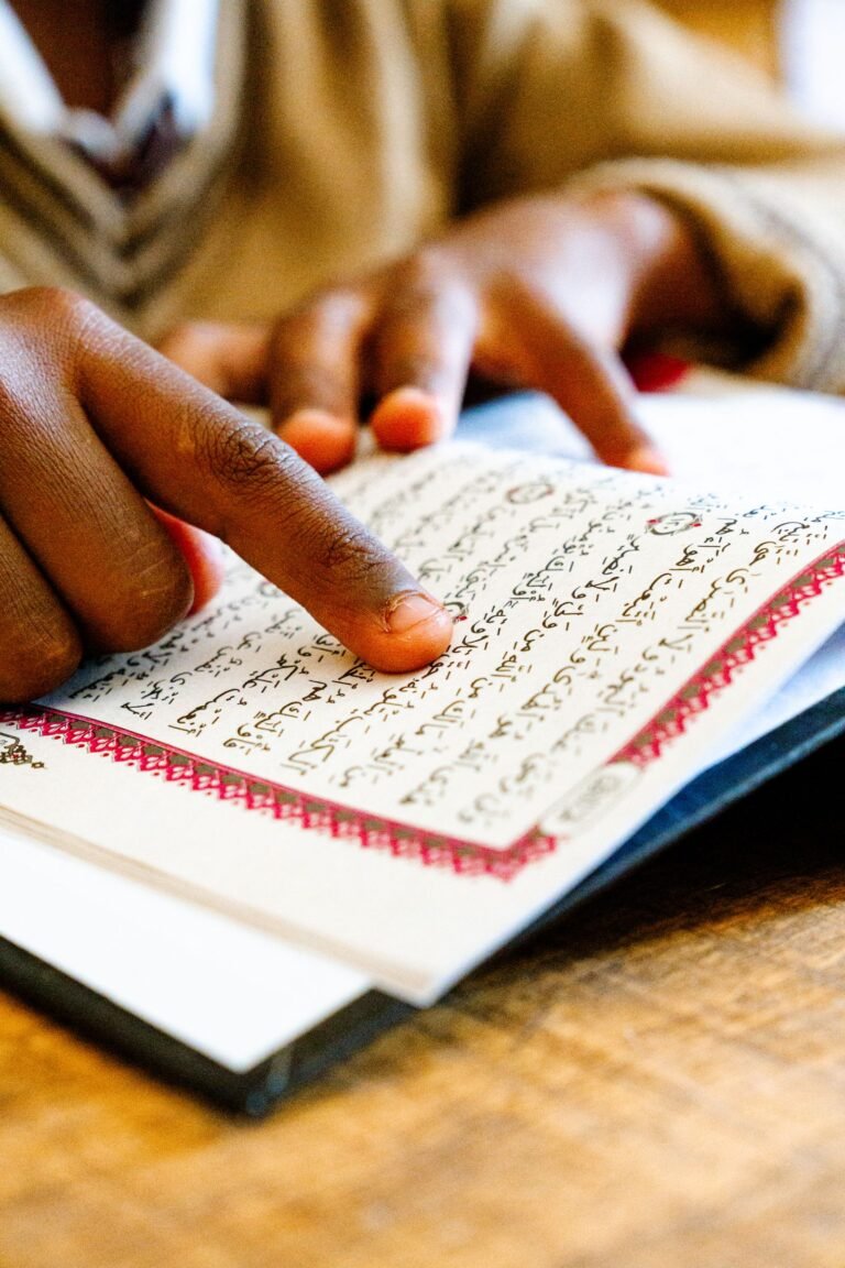 Child reading the Quran, finger following the text